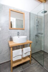 Custom shower enclosure in minimalist modern bathroom